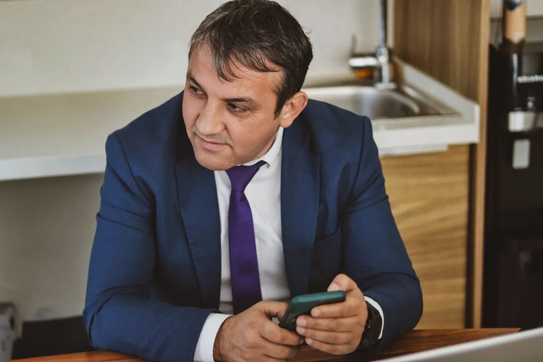 A resident checking his phone at home